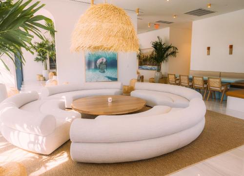 a living room with a white couch and a table at Flow Hotel Miami in Miami