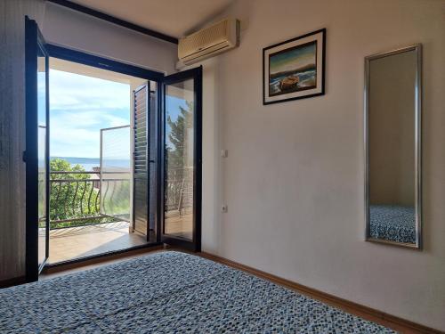 sypialnia z drzwiami wychodzącymi na balkon w obiekcie Apartment Starigrad 6621a w mieście Starigrad-Paklenica