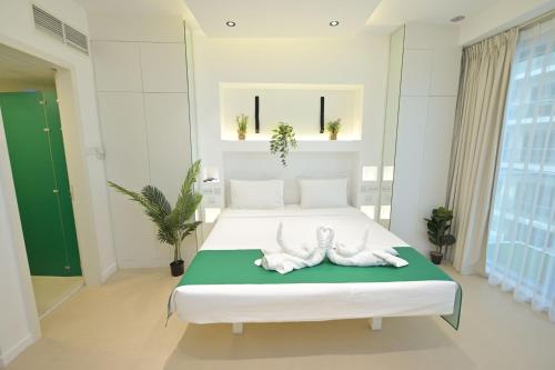 a bedroom with a bed with two animal statues on it at Discover the New and Improved Deep View Studio in Ras al Khaimah