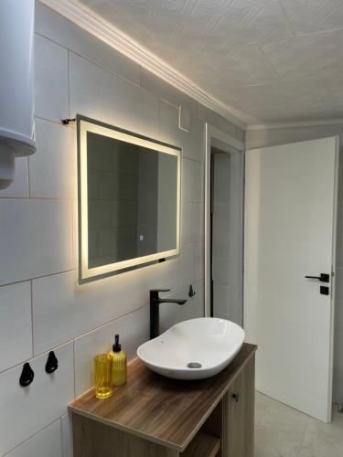 a bathroom with a white sink and a mirror at Bungalovi izvor Plive 3 in Šipovo