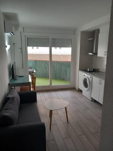 a living room with a couch and a table at Apartamento cerca del Mar in Empuriabrava