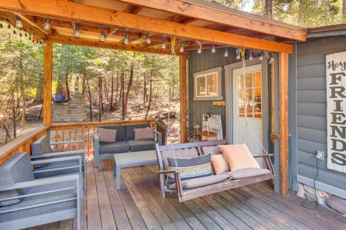 a porch with chairs and a couch on a house at Quaint Idyllwild Cabin half Mi to Trailhead! in Idyllwild