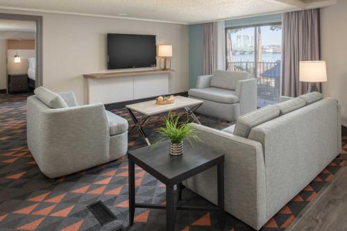 a living room with two couches and a television at Holiday Inn Portland - Columbia Riverfront by IHG in Portland