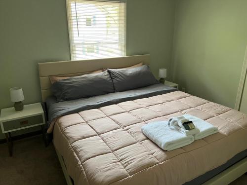 a bedroom with a bed with a towel on it at Perfectly located Waterhill home in Ann Arbor