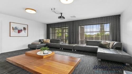 a living room with a couch and a table at Oceans 19 by Wine Coast Holidays in Sellicks Beach