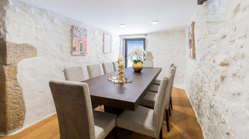 a dining room with a table and chairs at Quintinha Sao Martinho Luxury 2 Suites Villa Padrao With Sauna in Vila do Conde