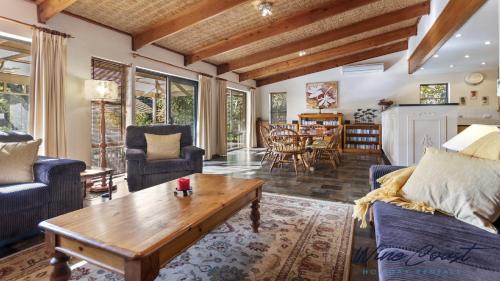 a living room with couches and a coffee table at Portavino by Wine Coast Holiday Rentals in Port Willunga