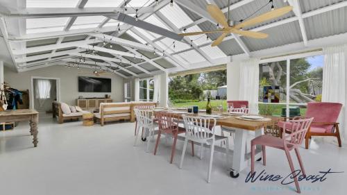 a dining room with a table and chairs at Sea Gypsy by Wine Coast Holiday Rentals in Aldinga Beach