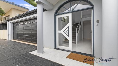 a pair of garage doors on a house at Ocean Views and Vineyards by Wine Coast Holiday Rentals in Seaford