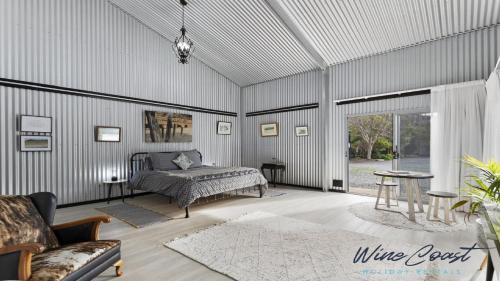a room with a bed and a couch in it at The Cubby House by Wine Coast Holiday Rentals in Willunga
