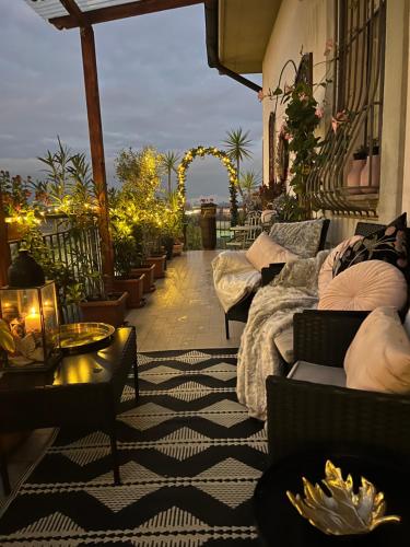 a patio with couches and tables on a balcony at Casa Italia Hospitality in Lunghezza
