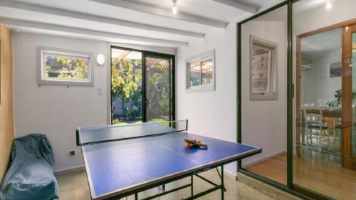 a ping pong table in the middle of a room at Sea-Vine Hideaway by Wine Coast Holiday Rentals in Port Willunga