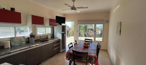 a kitchen with a table and a dining room at Lo de Marga - hasta 7 personas- in Federación