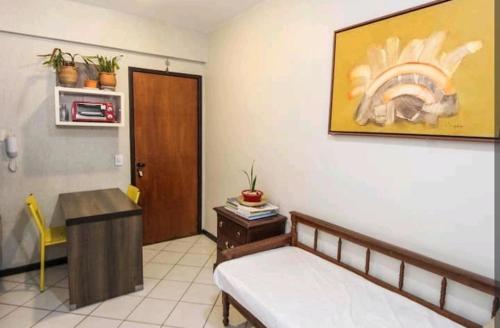 a room with a bed and a table and a desk at Flats Lago Norte MOTO CAPITAL 3 PESSOAS! in Brasilia