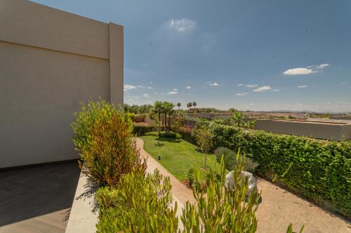 a view of a garden from a house at Villa Marrakech vue atlas in Marrakech
