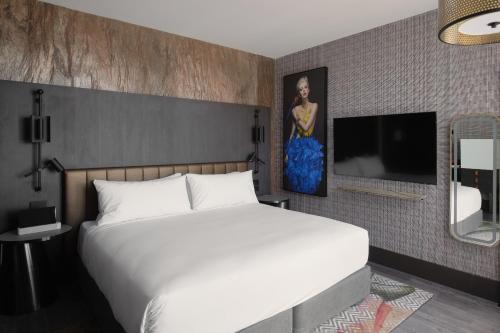 a bedroom with a bed and a painting on the wall at The Motley Hotel Richmond, Tapestry Collection by Hilton in Melbourne