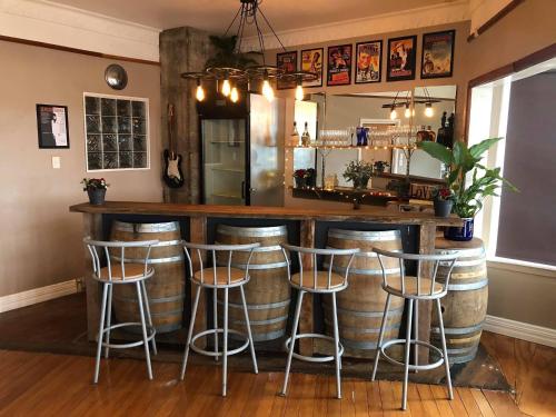a bar with a bunch of wine barrels at Snowy Waters - The Old Nurses Home in Raetihi