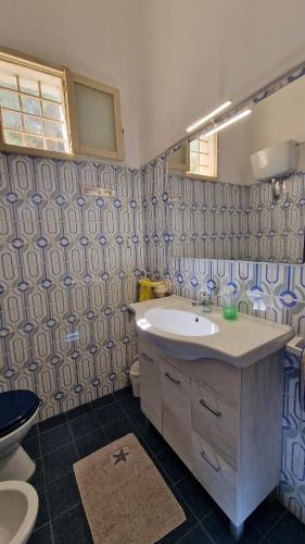 a bathroom with a sink and a toilet at Masseria Vivi il Salento in Santa Caterina di Nardò