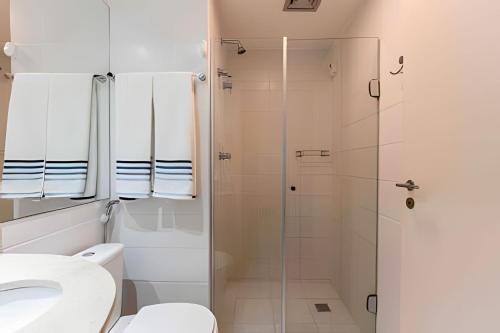 a bathroom with a shower and a toilet and a sink at Hotel VISION in Brasilia