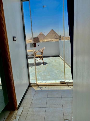 a view of the pyramids from the balcony of a building at Anubis Pyramids View in Cairo
