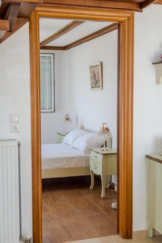 a mirror in a bedroom with a bed and a desk at Pantheon Villa Svoronata in Svoronata