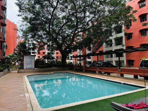 a swimming pool in the middle of a city at Olivia's Mi Casa in Lapu-Lapu, Cebu in Pusok