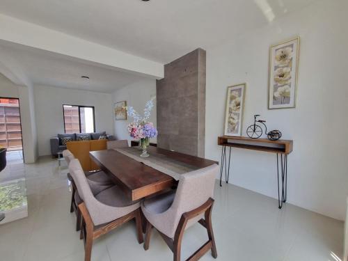 a dining room with a wooden table and chairs at Casa 16 in La Concepción