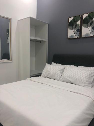 a bedroom with a white bed and a mirror at Calma Villa Hutan Kampung in Alor Setar