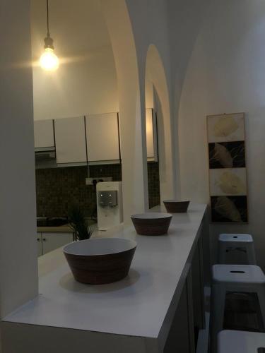 a kitchen with three bowls on a counter at Calma Villa Jalan Sultanah in Alor Setar