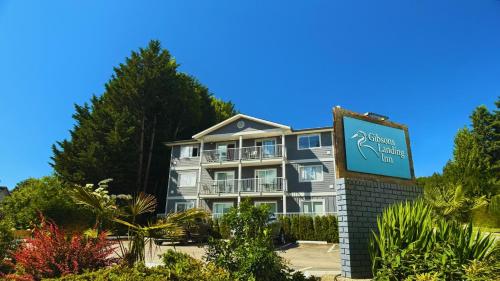 a building with a sign in front of it at Gibsons Landing Inn in Gibsons