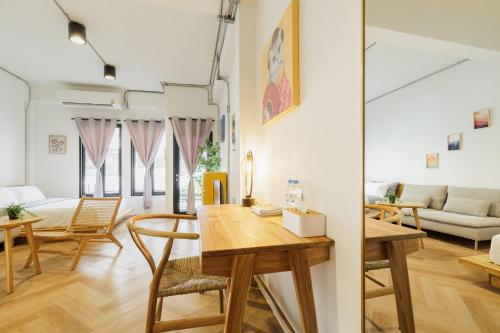 a dining room and living room with a table and chairs at Wabisabi Bangkok 3 MIN To Train Station in Bangkok