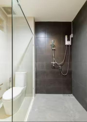 a bathroom with a shower with a toilet and a sink at Wabisabi Bangkok 3 MIN To Train Station in Bangkok