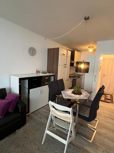 a living room and kitchen with a table and chairs at Atempause und erholsame Zeit im Harz in Braunlage