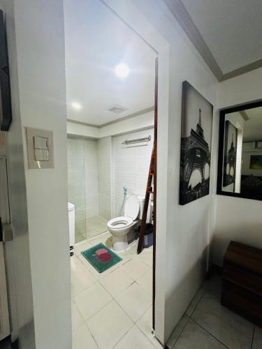 a bathroom with a toilet and a ladder in it at Olivia's Mi Casa in Lapu-Lapu, Cebu in Pusok