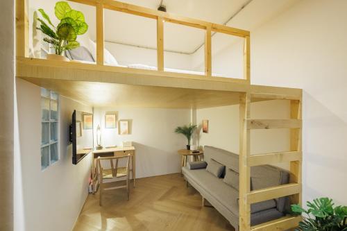 a room with a loft bed and a desk at Wabisabi Bangkok 3 MIN To Train Station in Bangkok