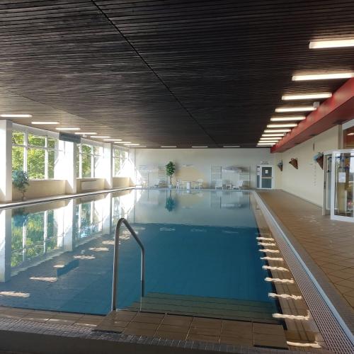 a large swimming pool in a building at Atempause und erholsame Zeit im Harz in Braunlage