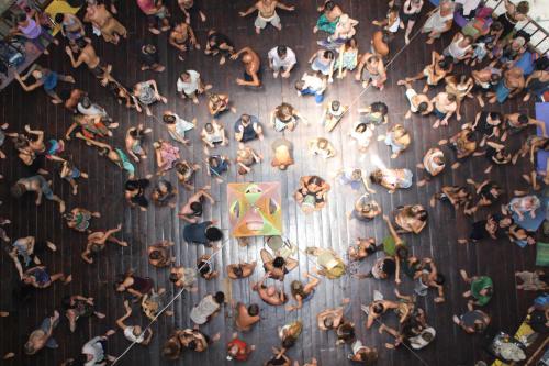 an overhead view of a crowd of people standing around a table at Pyramid Yoga Koh Phangan in Koh Phangan