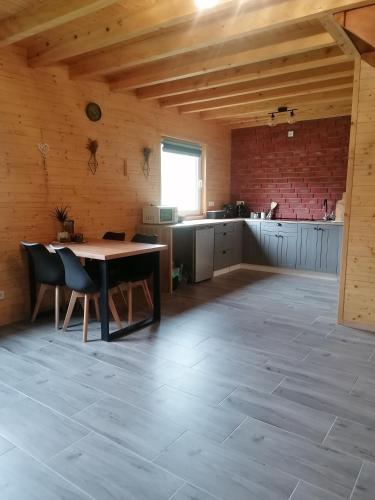 a kitchen with a table and chairs in a room at Lisi Zakątek in Czarna