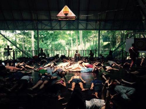 a group of people laying in the water at a stage at Pyramid Yoga Koh Phangan in Koh Phangan