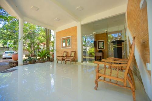 a living room with a fireplace in a house at Hotel Varsha in Kekirawa