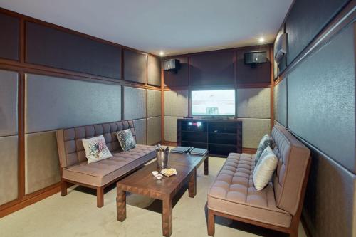 a living room with two couches and a coffee table at Two Seasons Coron Island Resort in Coron