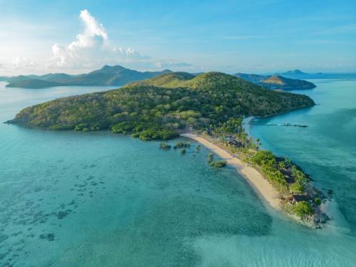 an island in the ocean next to a body of water at Two Seasons Coron Island Resort in Coron