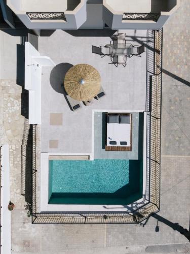 an overhead view of a pool with an umbrella at Matala Bay in Style Apartments in Matala