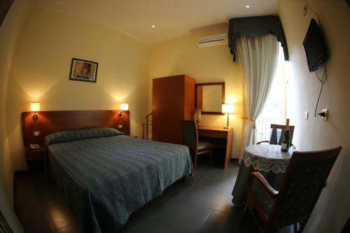 Postel nebo postele na pokoji v ubytování Hotel Nettuno