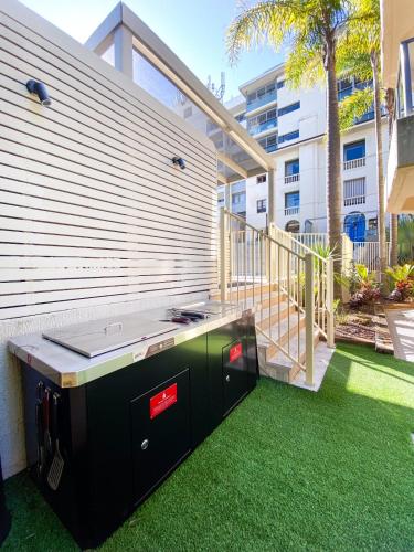 a backyard with a grill and green grass at Peppers Manly Beach in Sydney