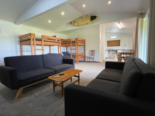 a living room with a couch and a bunk bed at Lot 4 Retreat 150 Willson Drive in Normanville