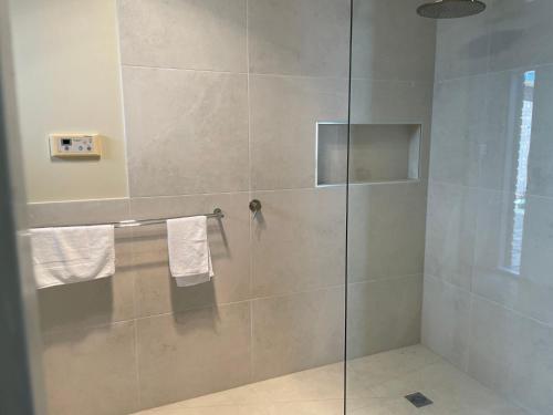 a shower with a glass door in a bathroom at Waterside Mulwala in Mulwala