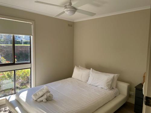 a bedroom with a bed with a stuffed animal on it at Waterside Mulwala in Mulwala