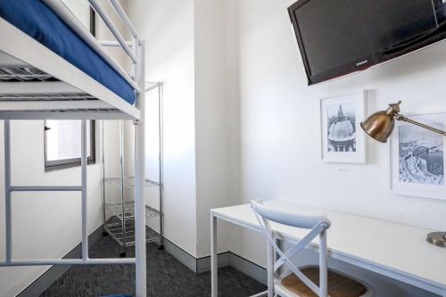 a bedroom with a desk and a bunk bed at Wake Up! Sydney Central in Sydney