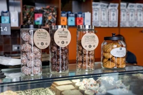 a counter with jars of different types of food at Wake Up! Sydney Central in Sydney